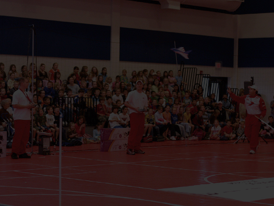 Litespeed pilots performing an indoor aircraft demonstration for students